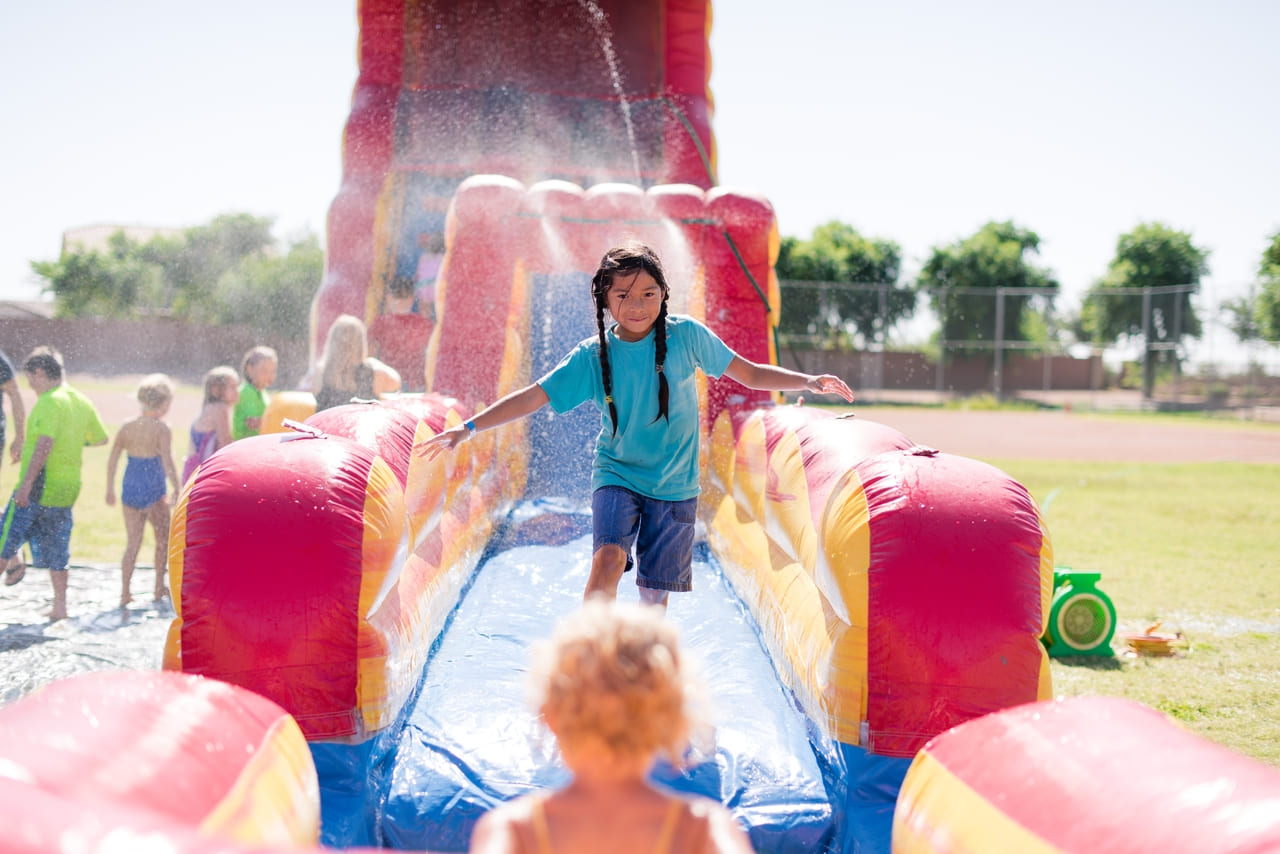 girl-enjoying-a-water-slide-2024-12-02-10-20-30-utc